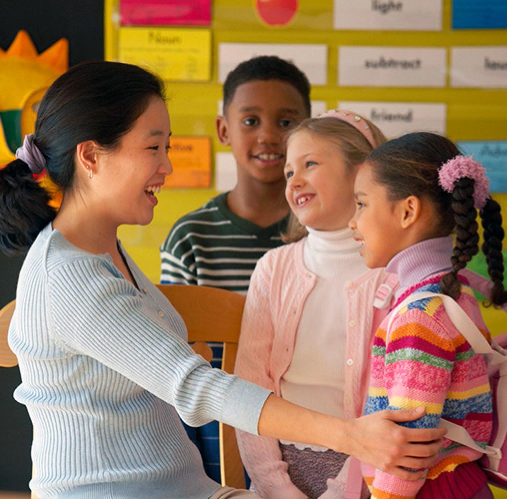 Teacher at eye level with elementary aged students