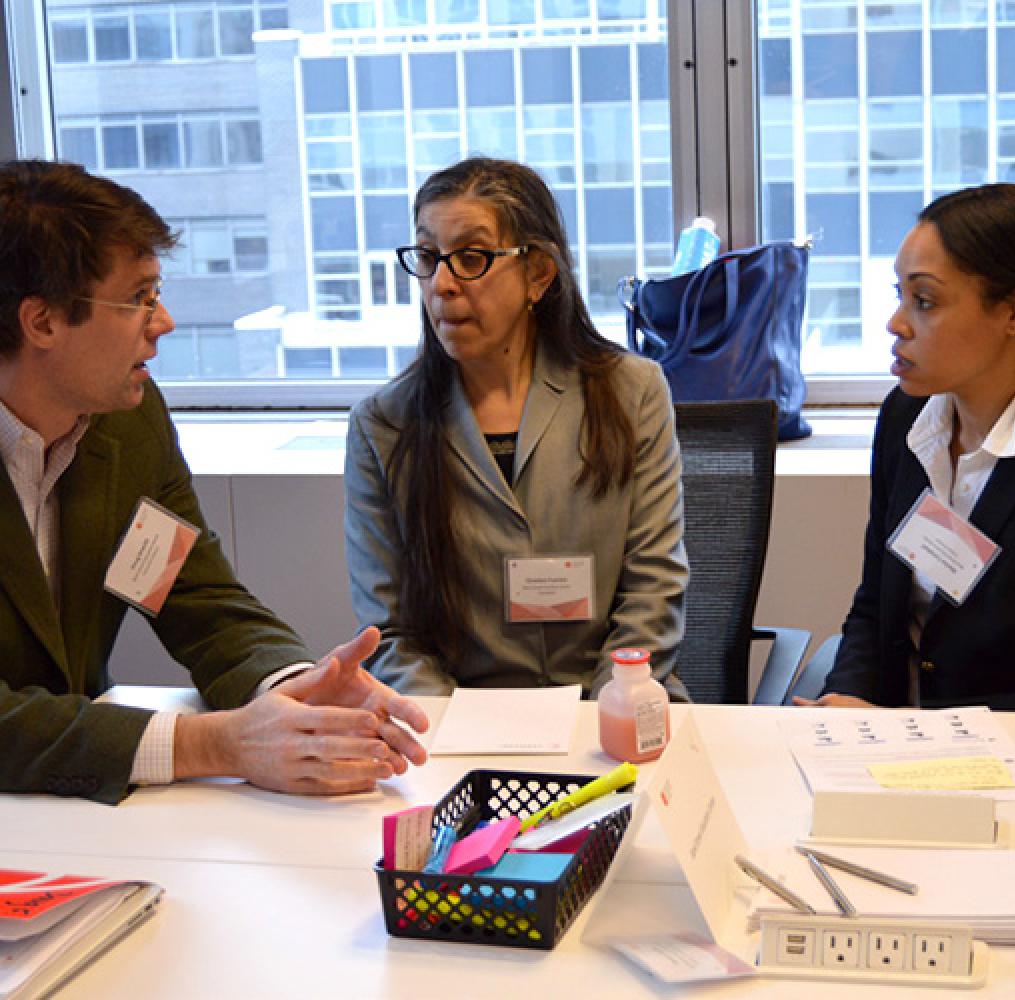 A group of adults having a discussion at a conference table