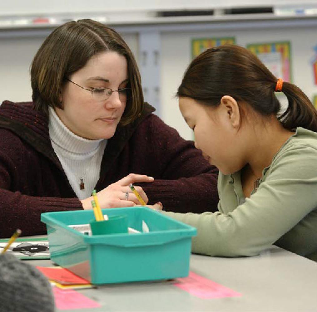 Female teacher with Asian student