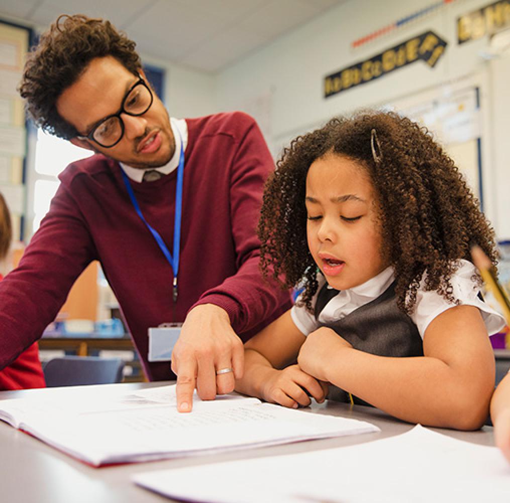 Teacher working with elementary age girl