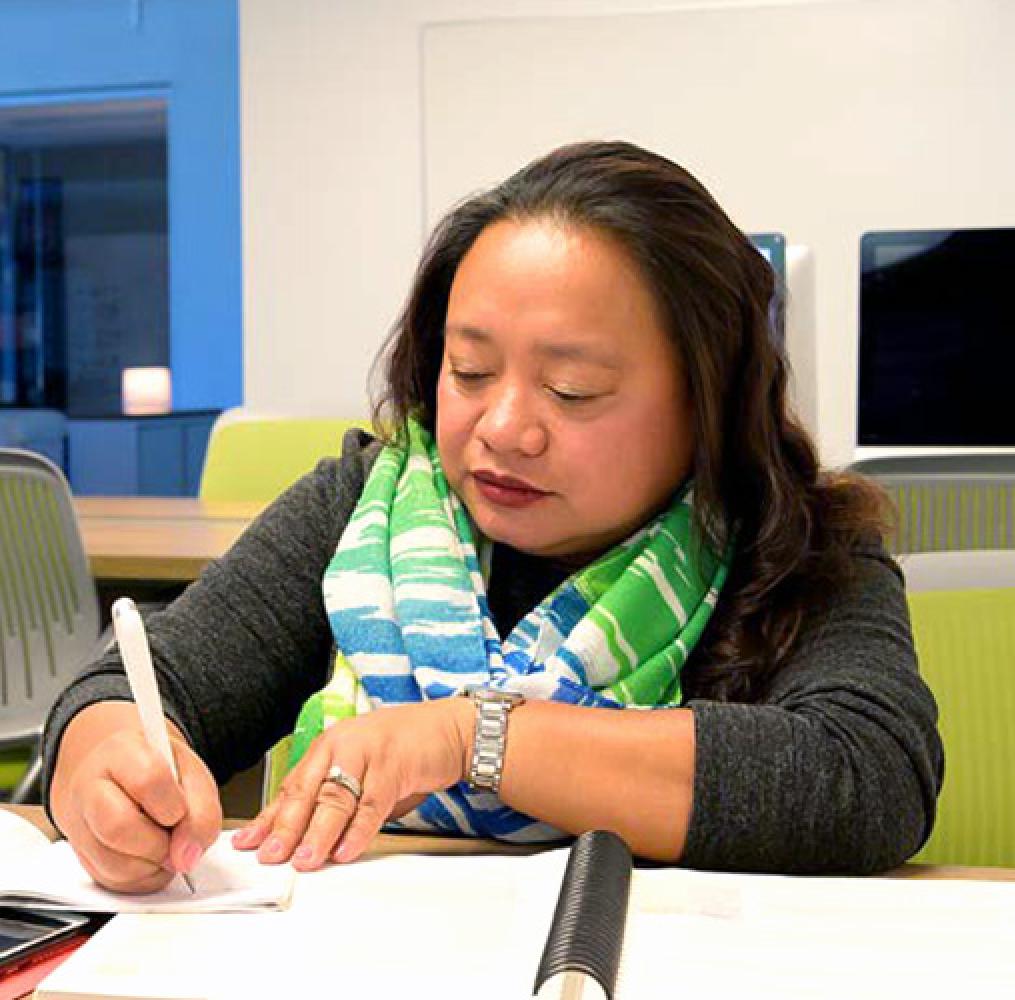 Woman taking notes at a desk