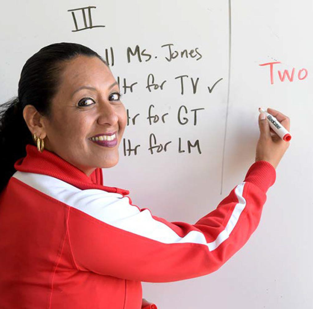 Teacher writing on white board