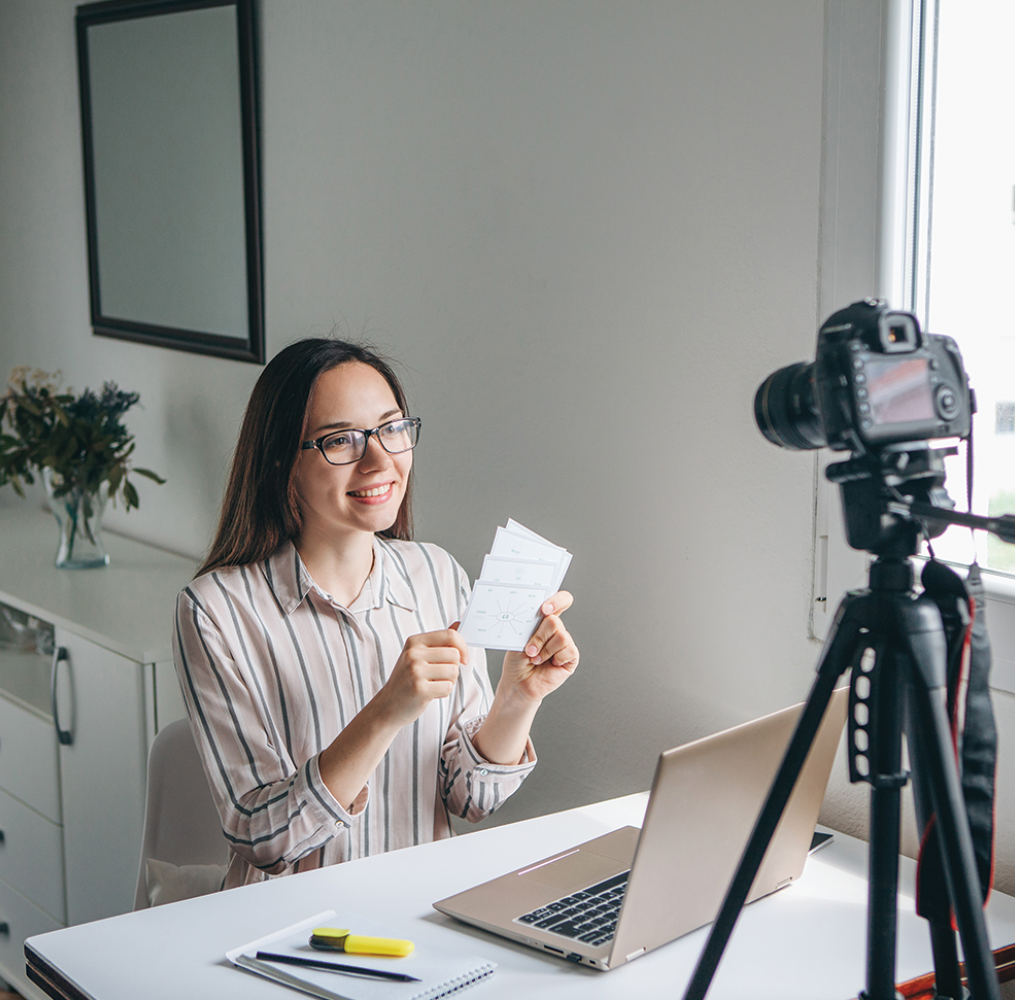 Woman remotely teaching in front of computer and camera