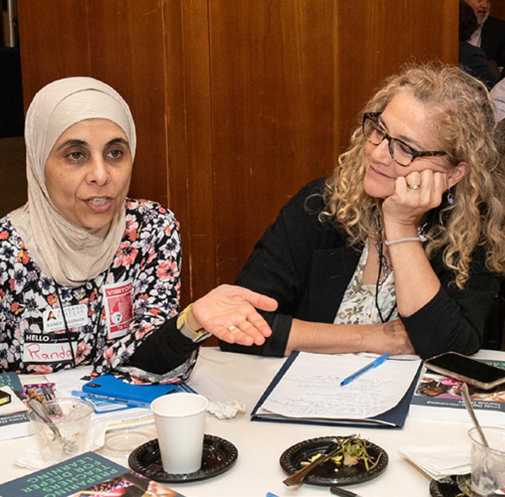 Two women having a discussion at a table