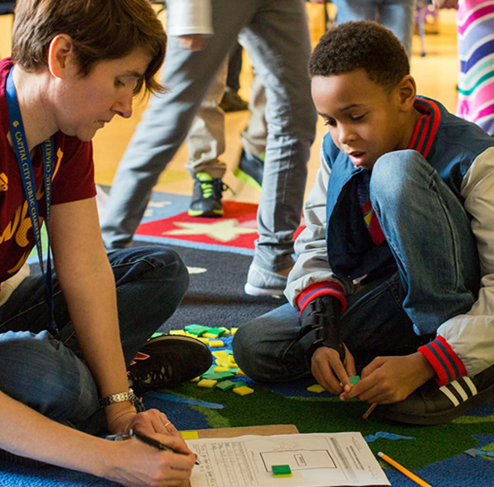 Teacher and student working on a project