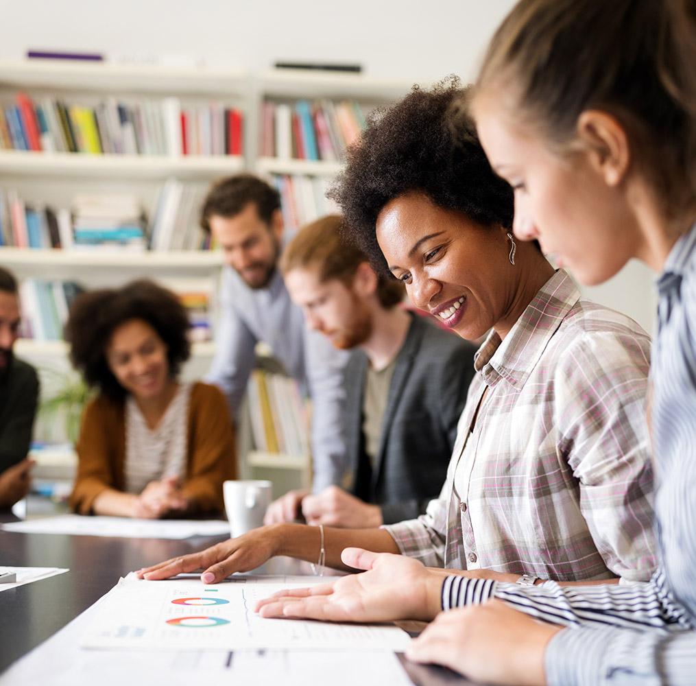 Group of people working collaboratively in an academic setting.