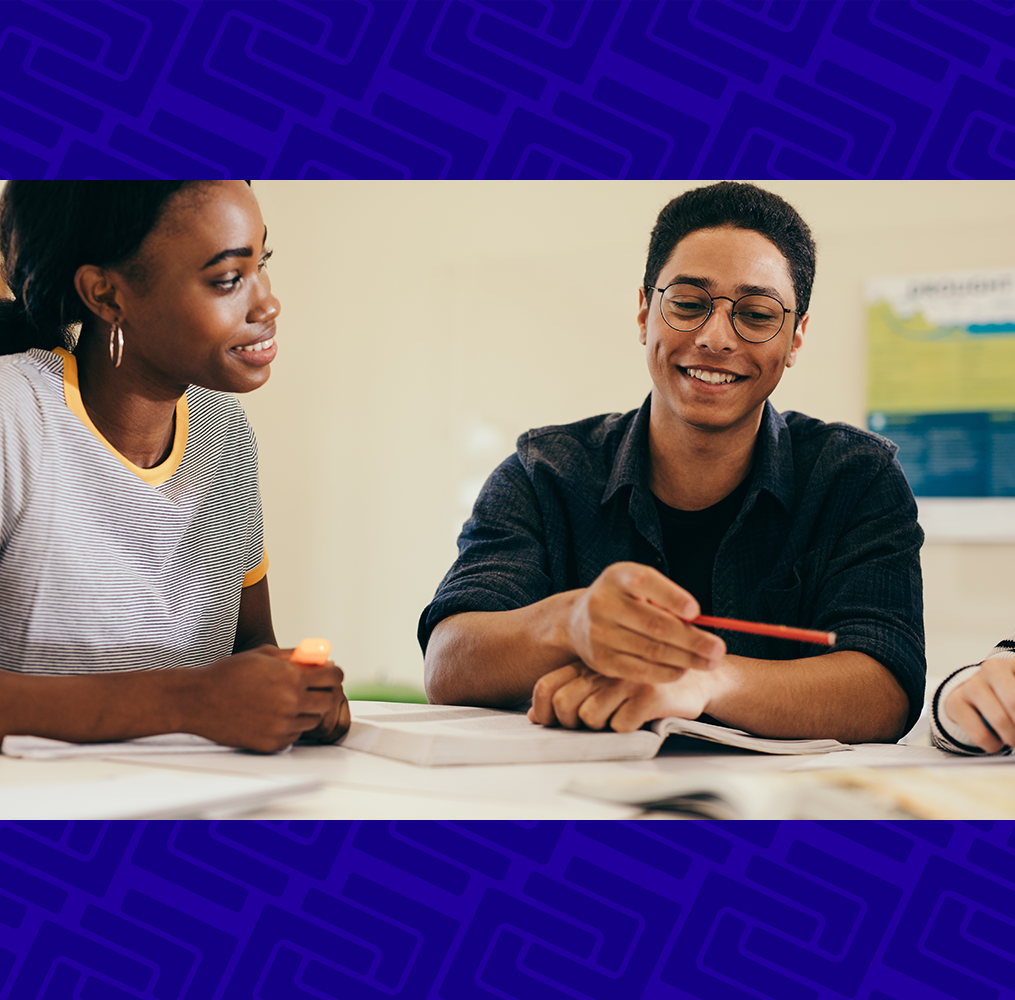 Adult students sitting a table discussing an assignment