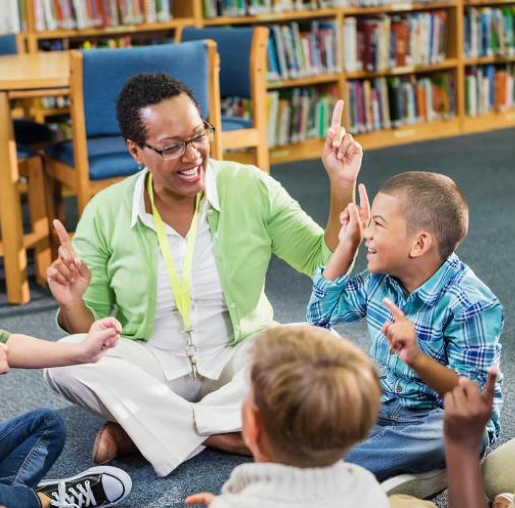 Teacher and elementary school students sitting in a circle