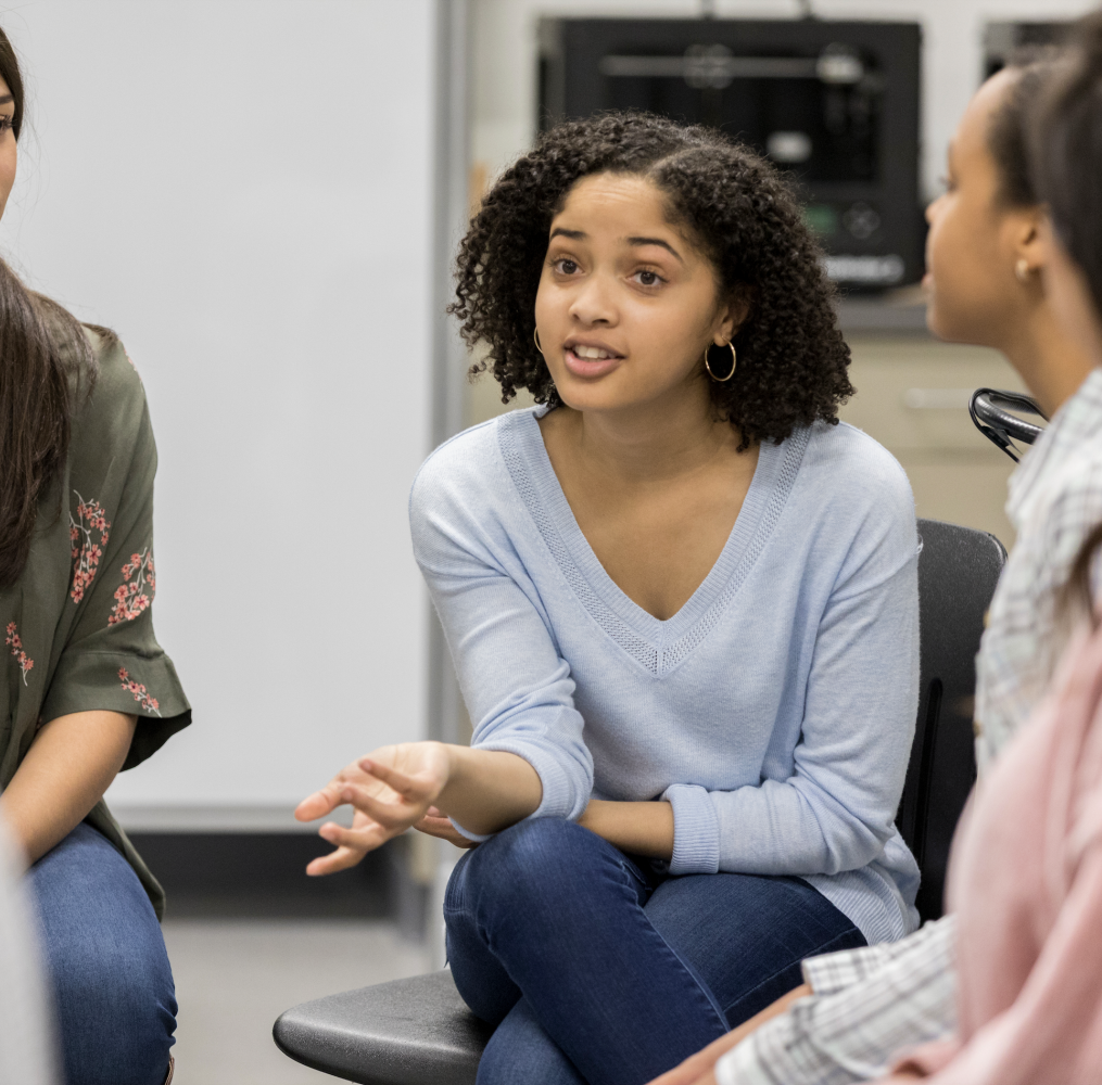 Young adult having a discussions with peers.