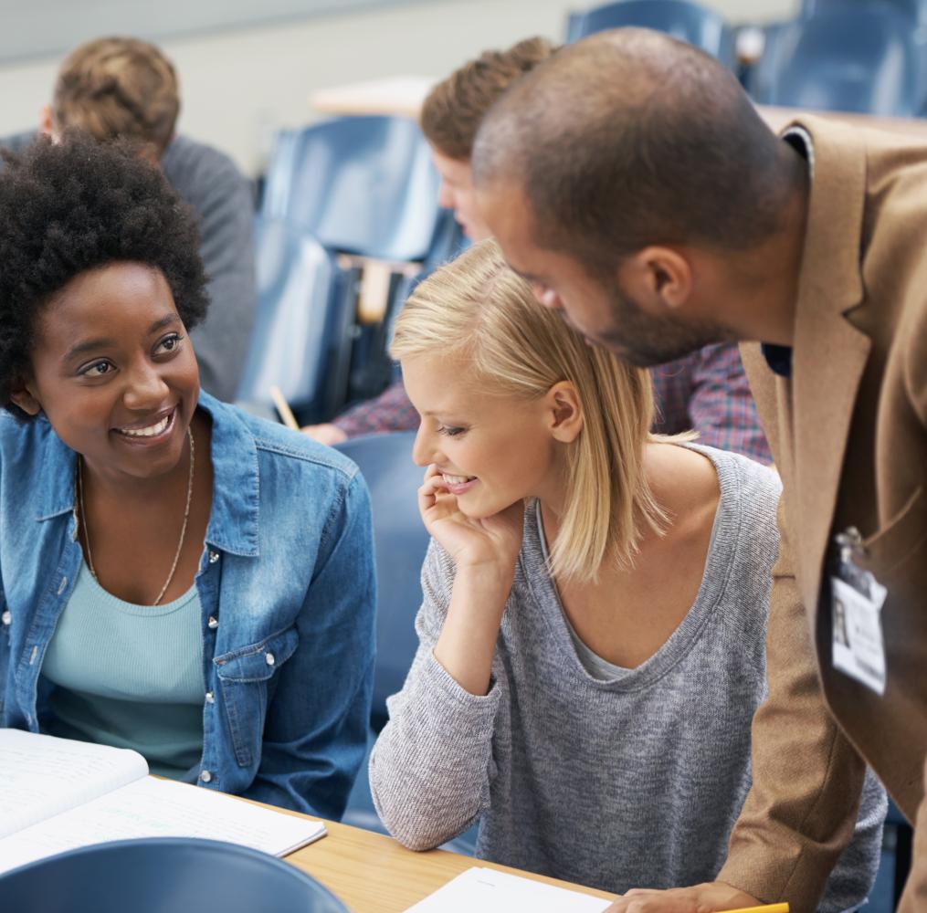 Three adults having a discussion in a college setting.