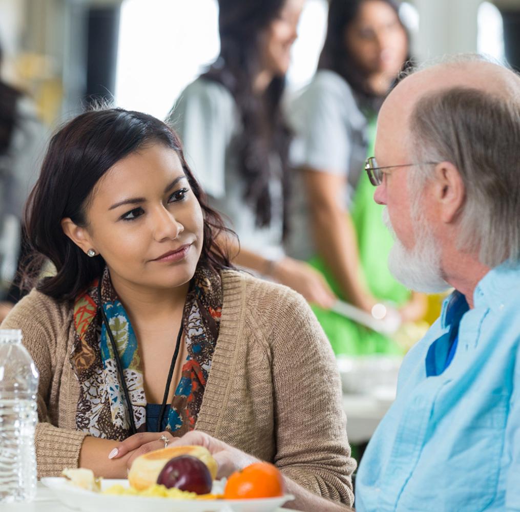 Two teachers having a discussion over lunch.