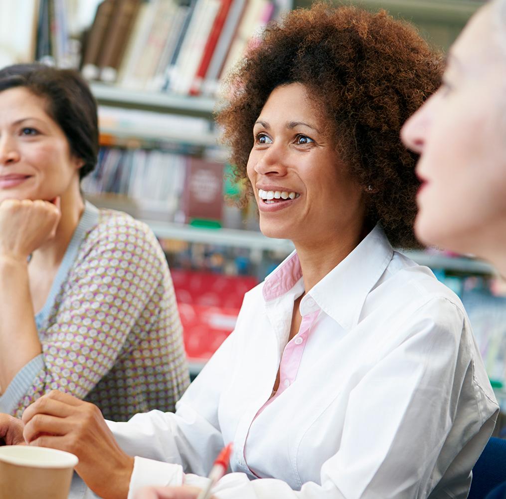 Group of teachers listening to a speaker.