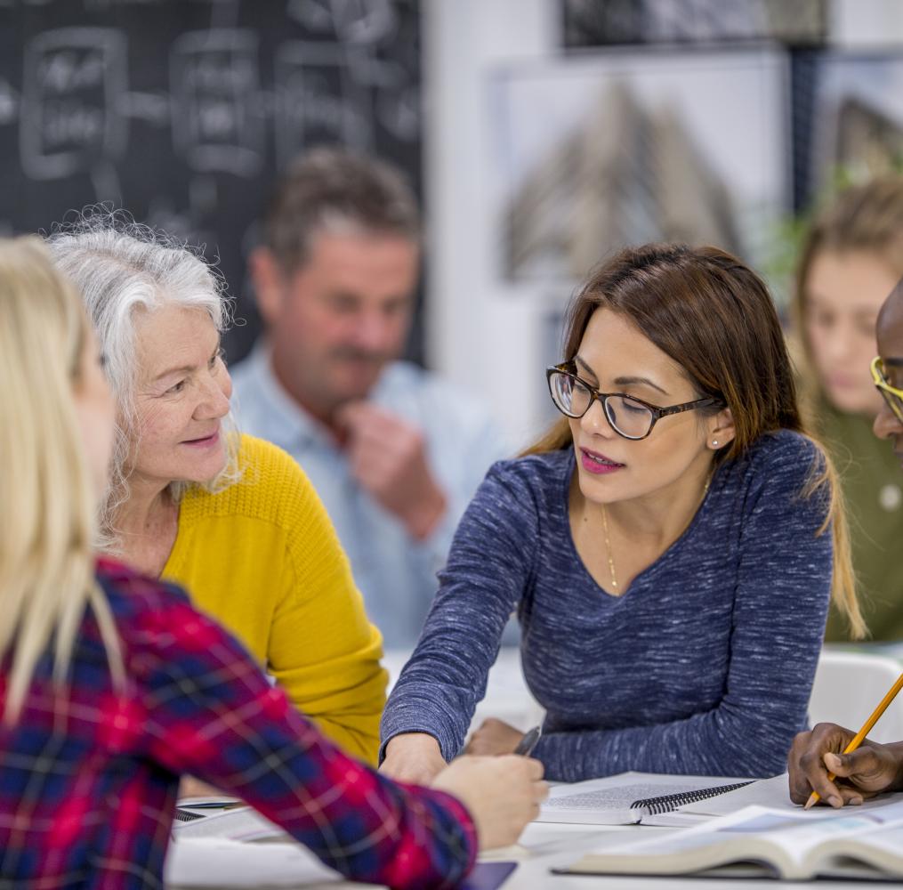 A group of adults having a discussion at a table.