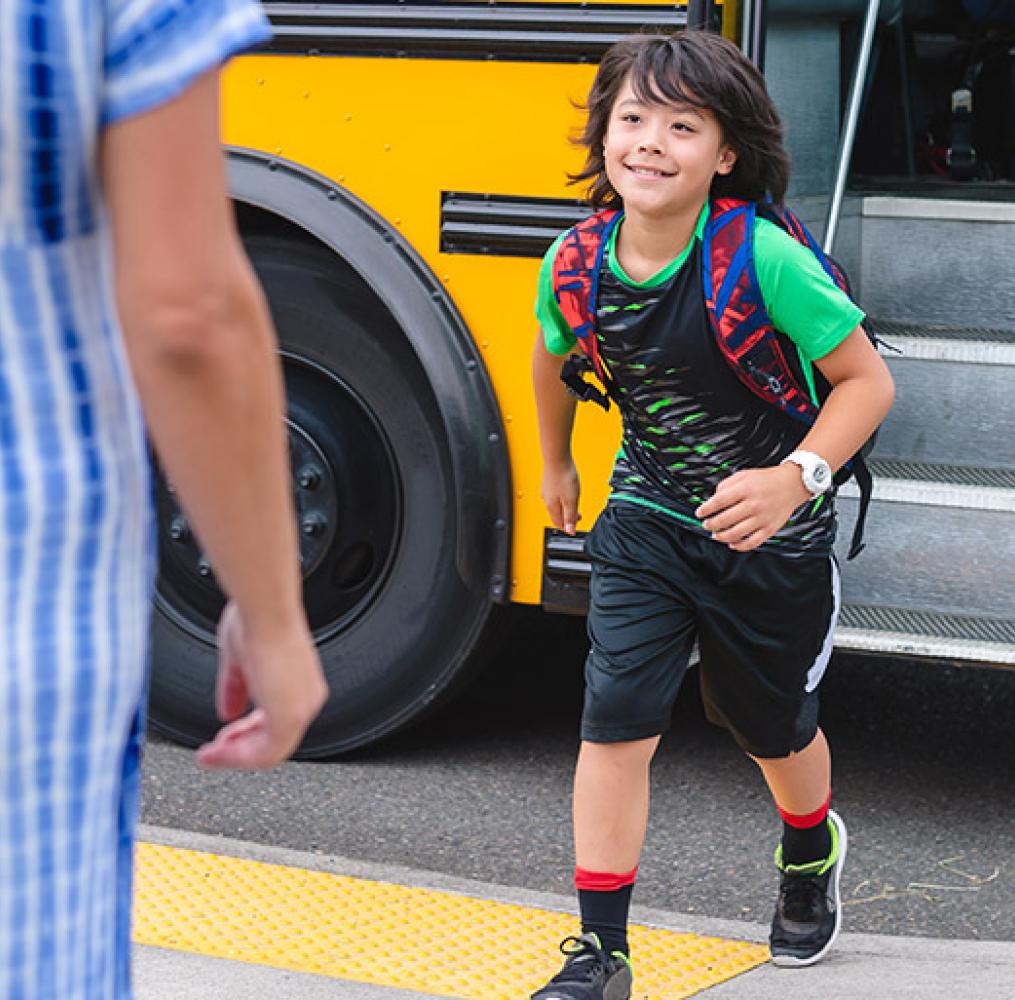 Student getting off of a school bus.