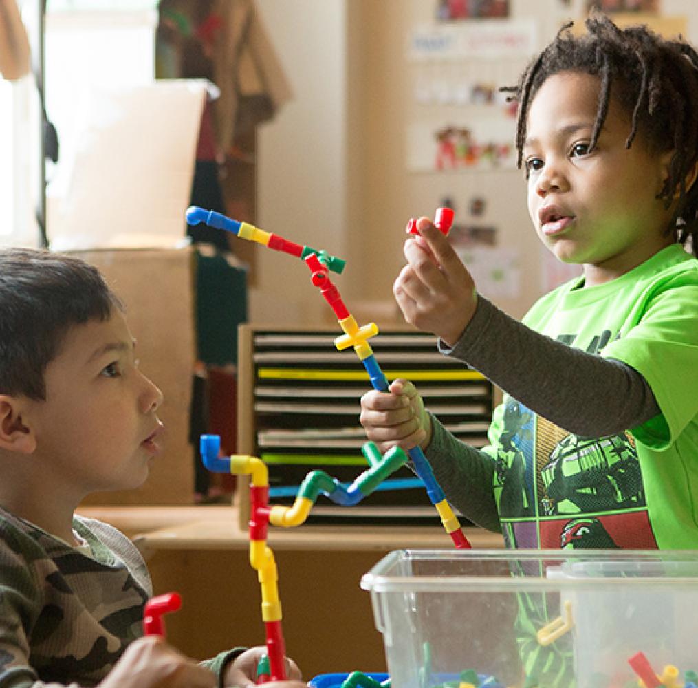 Two children playing with an educational toy.