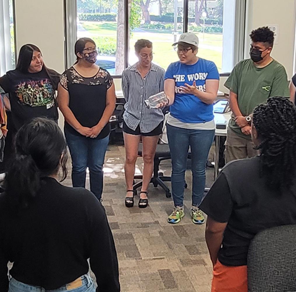 Group of student teachers standing in a circle for a group project.