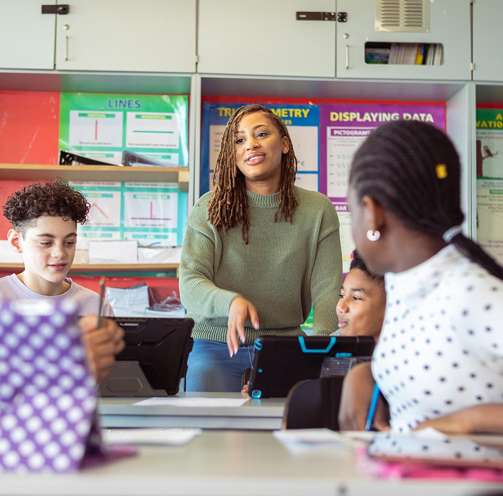 Teacher answering questions as students work in class