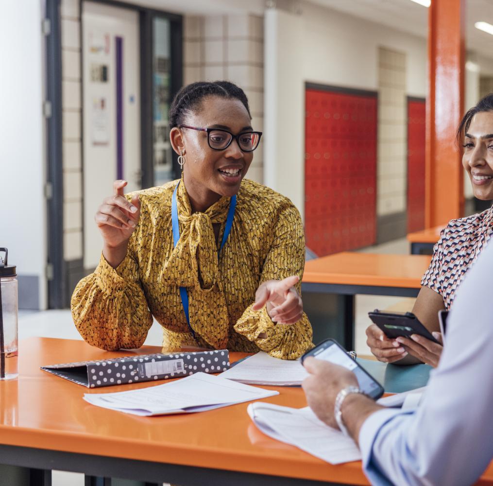 A group of educators having a discussion at a table.