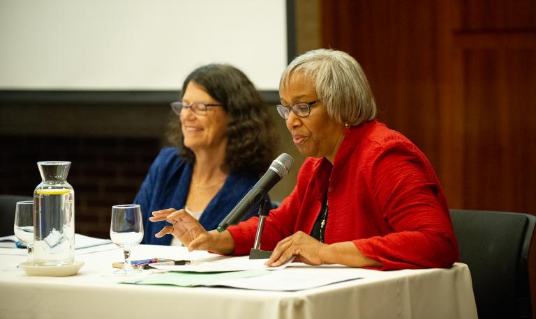 Two panelists presenting at event