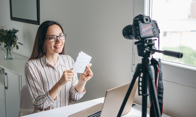 Woman remote teaching in front on computer and camera