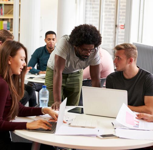Group of adults working together in a library.