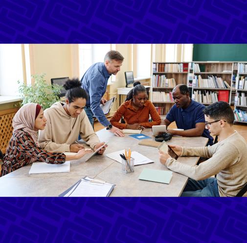 Group of adult students and teacher working collaboratively.