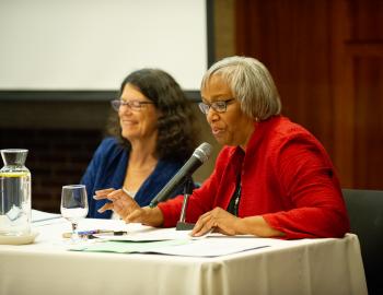 Two panelists presenting at event