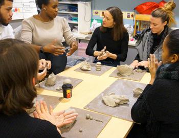 group of adults working on a project with modeling clay