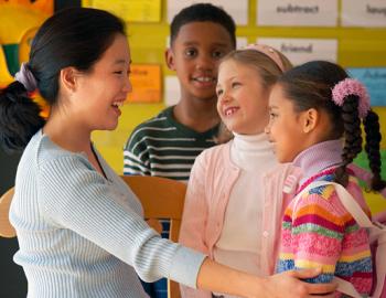 Teacher at eye level with elementary aged students