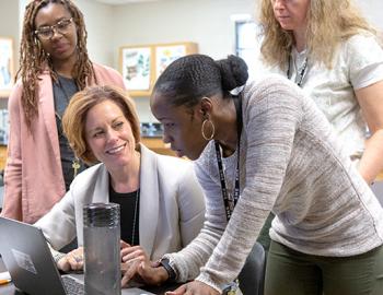 A photo of a group of people conducting a meeting