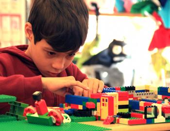 Elementary aged boy working with blocks