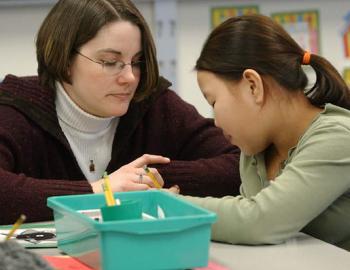 Female teacher with Asian student