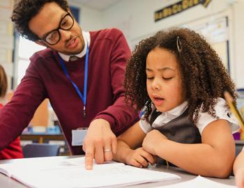 Teacher working with elementary age girl