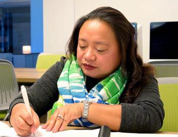 Woman taking notes at a desk