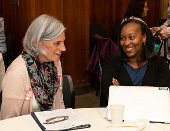 Two people in conversation at convening on educator preparation