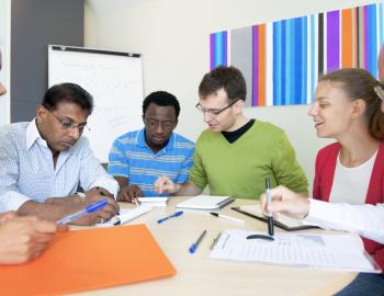 Group of educators seated around a table.