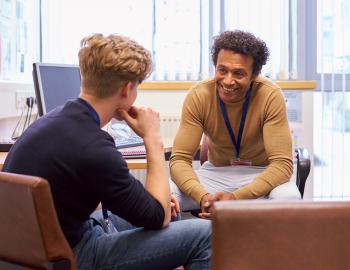 Student talking with a school counselor.