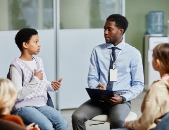 Students having a discussions with a teacher.