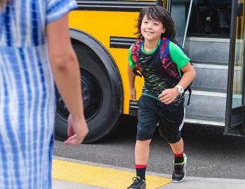 Student getting off of a school bus.