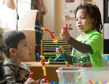 Two children playing with an educational toy.
